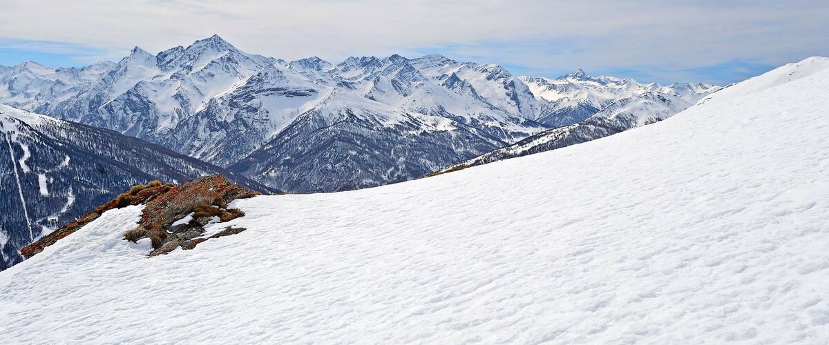 Majestic peaks in a winter scenery with Sestriere ski resort in the background, Piedmont, italian Alps
