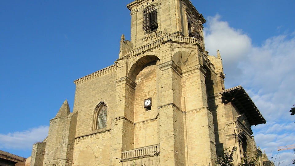 A historic church with a bell tower, arched windows, and a clock.