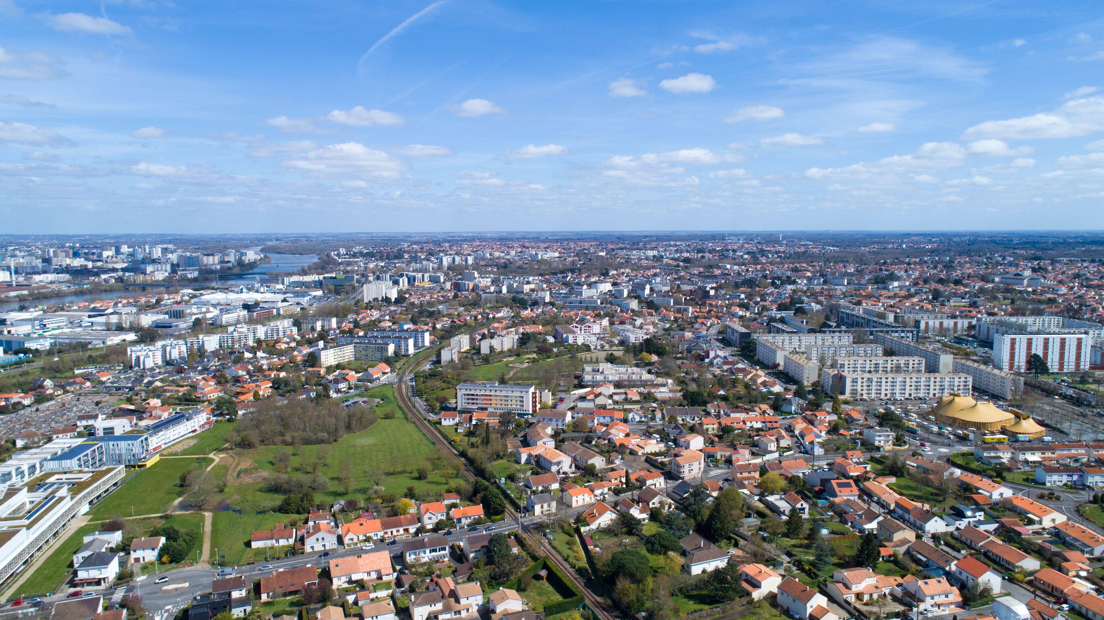 A cityscape with a river, residential areas, and industrial buildings.