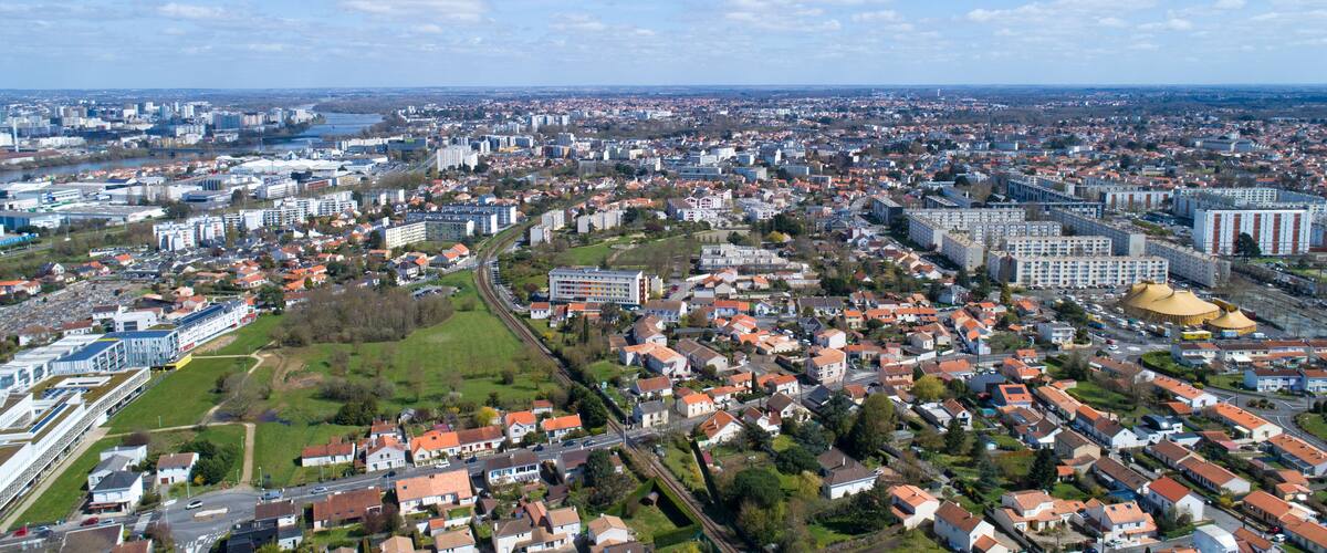 A cityscape with a river, residential areas, and industrial buildings.