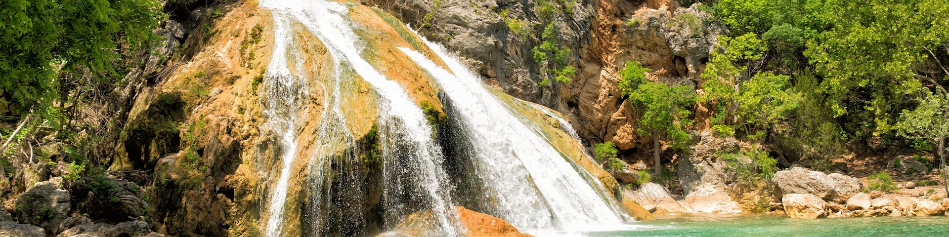 Water cascading over rocks into a natural pool at Turner Falls in Oklahoma in spring