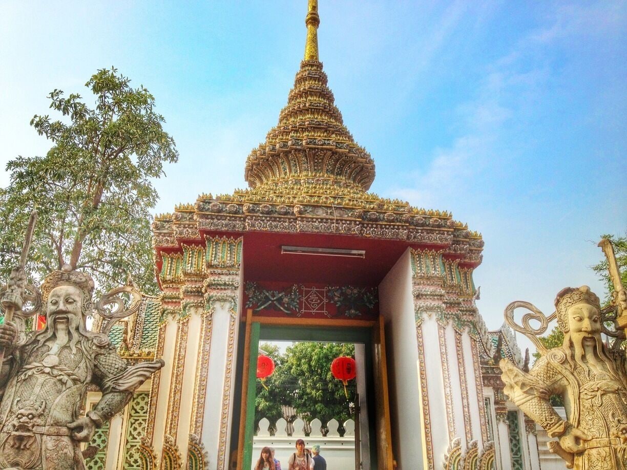 One of sixteen gates into the complex of Wat Pho guarded by Chinese giants. Wat Pho is known for the enormous 45 meter long, reclining Budda and is also known as the center of Thai massage. 
The Grand Palace and the Chao Praya river are close by as other must-see sites.
#Architecture