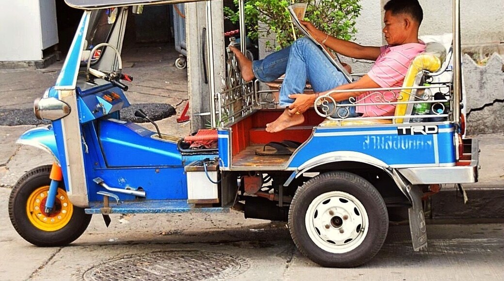 Tuk Tuk driver outside the hotel, waiting for a customer to take on a slightly dangerous an exciting ride. Most every visitor should try it at least once, but hold on tight.