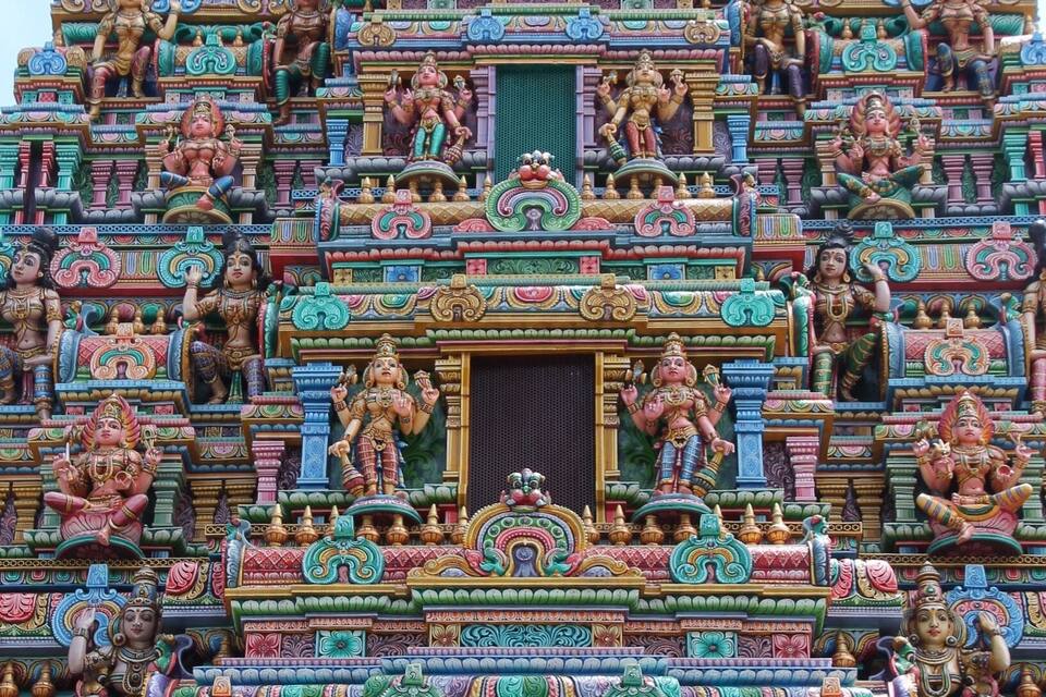 A colorful temple with intricate carvings and statues.