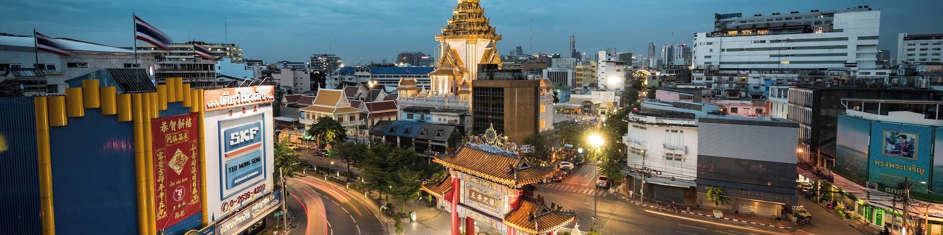 China Town Gate
This can be found at the junction of Yaowarat Road and Charoenkrung road. Both in the picture as they merge at an angle on to this round-a-bout / traffic circle.
The picture is taken from a parking garage accessed from Tri Mit Road. You may need to hand over a few Baht to the attendant. In my case she even shoed me to the correct floor for the best picture.