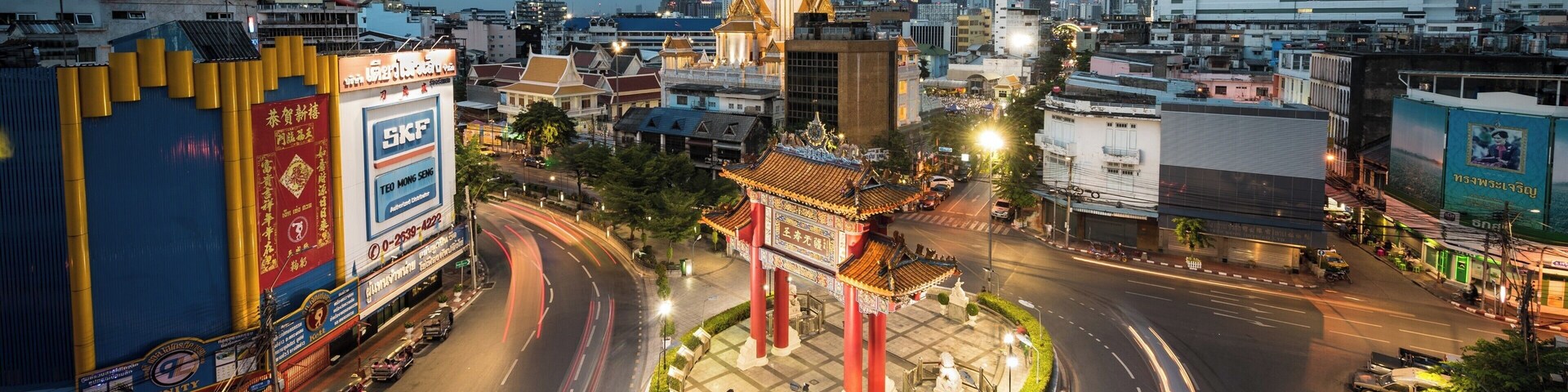 China Town Gate
This can be found at the junction of Yaowarat Road and Charoenkrung road. Both in the picture as they merge at an angle on to this round-a-bout / traffic circle.
The picture is taken from a parking garage accessed from Tri Mit Road. You may need to hand over a few Baht to the attendant. In my case she even shoed me to the correct floor for the best picture.