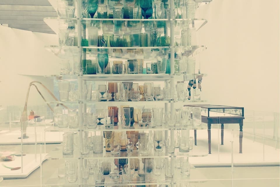 A modern glass display with various glassware.
