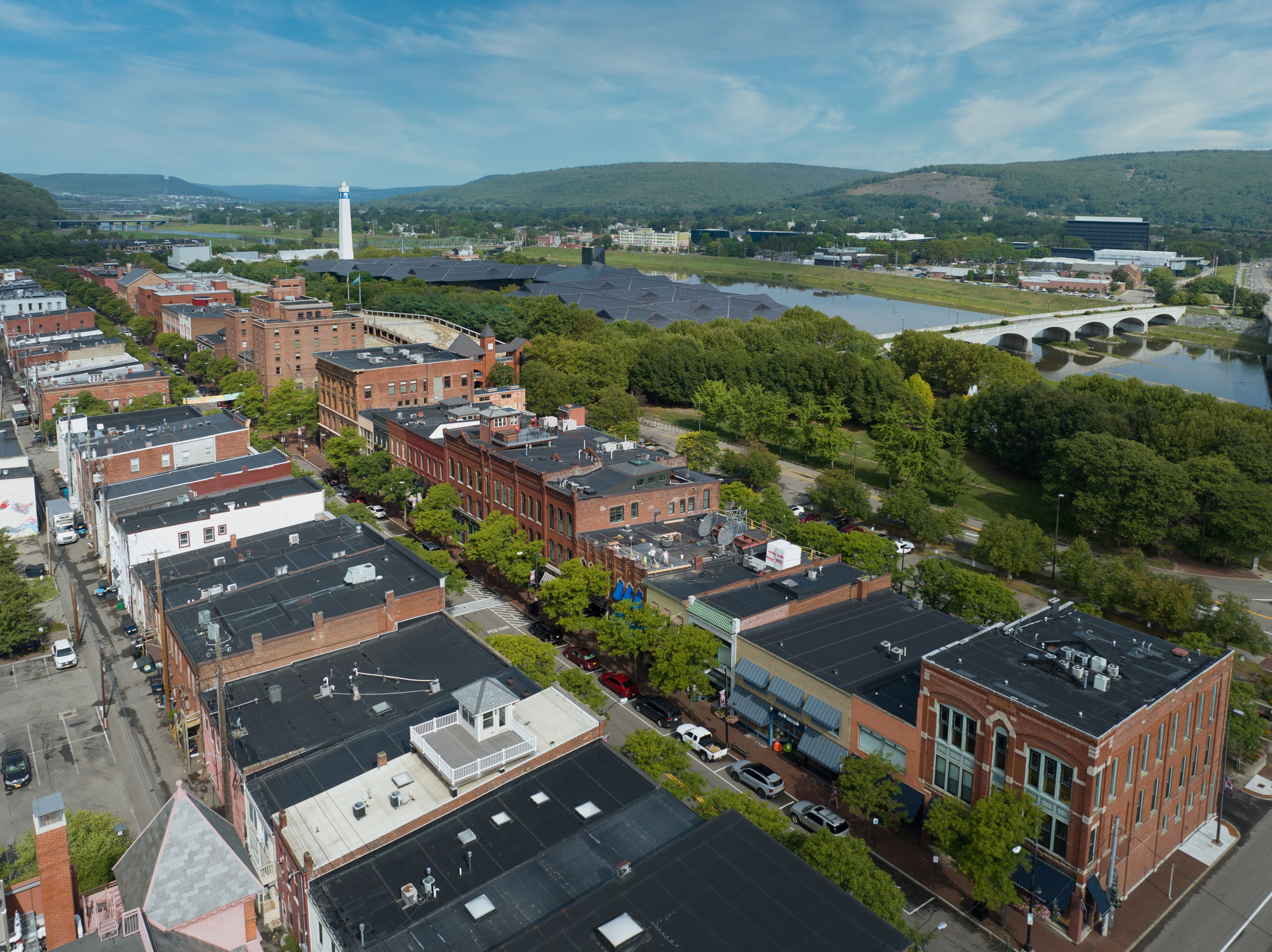 Aerial view of Corning Market Street downtown area with brick facade buildings next to the Glass factory