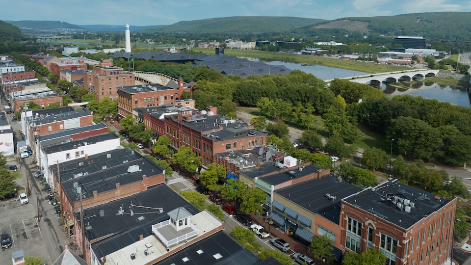 Aerial view of Corning Market Street downtown area with brick facade buildings next to the Glass factory