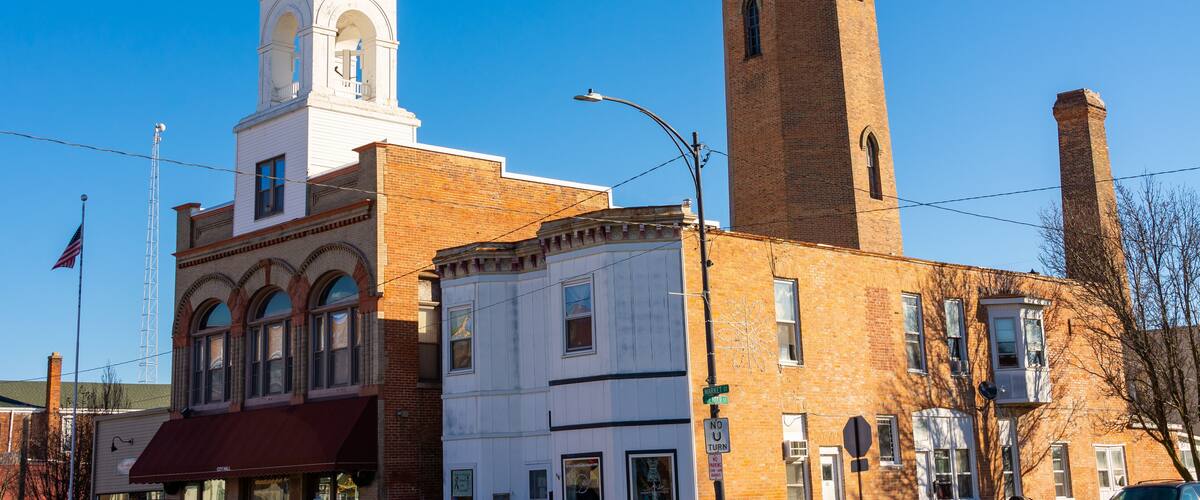 A historic building with a clock tower and a tall brick tower.