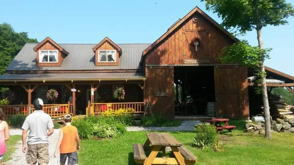 A rustic wooden building with a sign reading "SUGAR House."