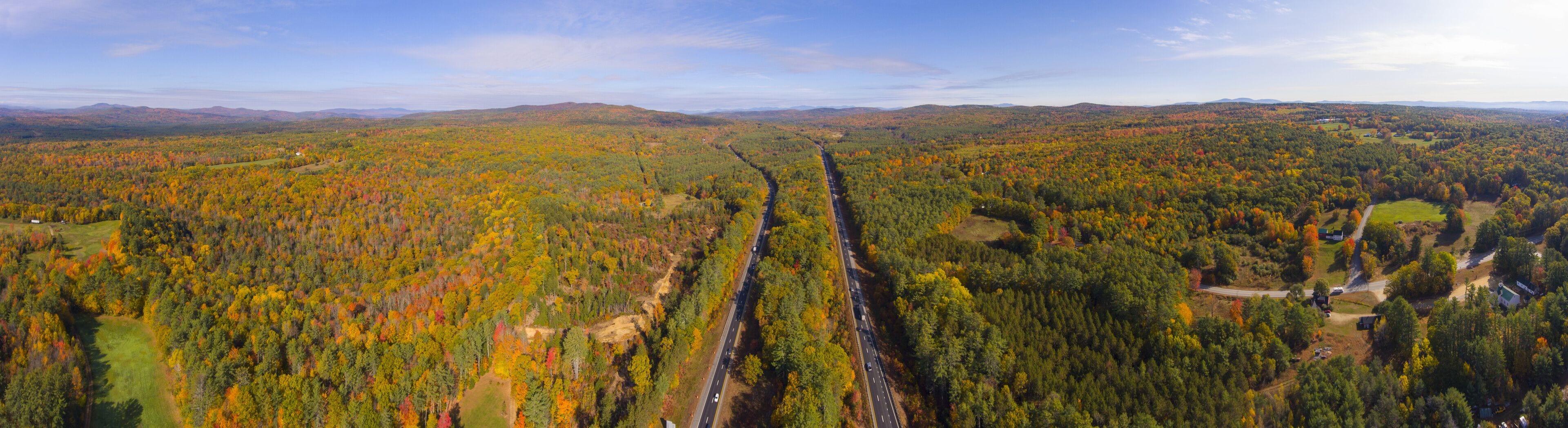 Interstate Highway 93 at Exit 22 with NH Route 127 in White Mountain National Forest panorama aerial view with fall foliage, Town of Sanbornton, New Hampshire NH, USA.