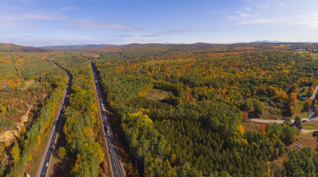 Interstate Highway 93 at Exit 22 with NH Route 127 in White Mountain National Forest panorama aerial view with fall foliage, Town of Sanbornton, New Hampshire NH, USA.