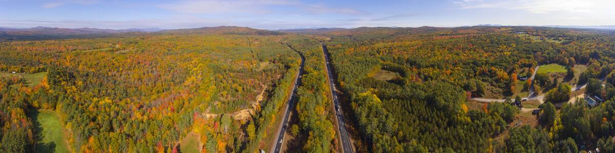 Interstate Highway 93 at Exit 22 with NH Route 127 in White Mountain National Forest panorama aerial view with fall foliage, Town of Sanbornton, New Hampshire NH, USA.