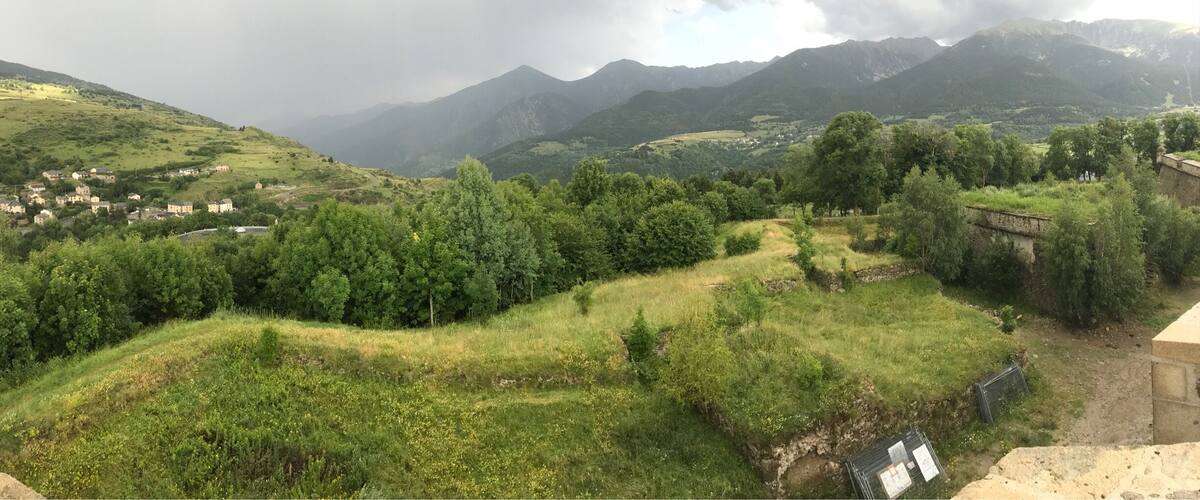 A mountainous landscape with a village nestled in the valley.