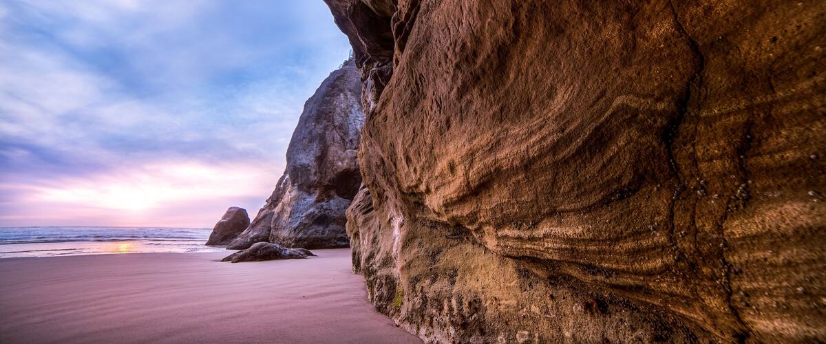 View of a sandy beach from inside a cave, Hug Point State Recreation Site, Arch Cape, Oregon, USA