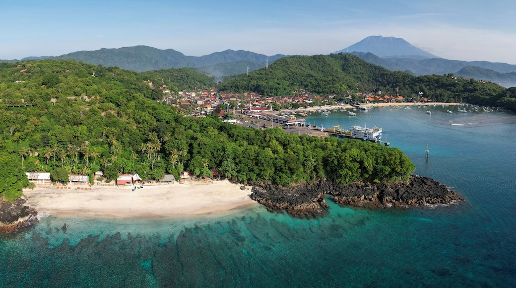 Panoramic aerial view of Bias Tugel Beach, Padangbai bay and Mount Agung on sunny day. Manggis, Bali, Indonesia.