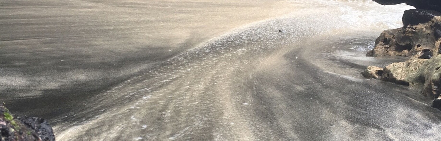 A little beach with a mix of black and white sand
Be careful because there is a strong current