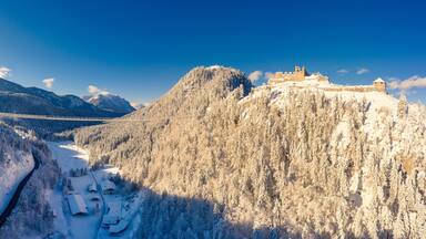 pedestrian suspension bridge over hermitage and ruin ehrenberg in reutte in the snow-covered winter with sunbeams