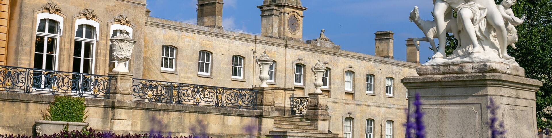 Historic country estate of Wrest Park in Bedfordshire, featuring the grand house constructed between 1834 and 1839 alongside landscaped gardens, a clock tower, and service buildings. Managed by EH