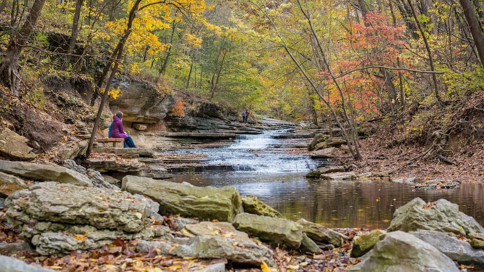 Tourists sitting on bench at Tanyard Creek Nature Trail Bella Vista, Northwest Arkansas