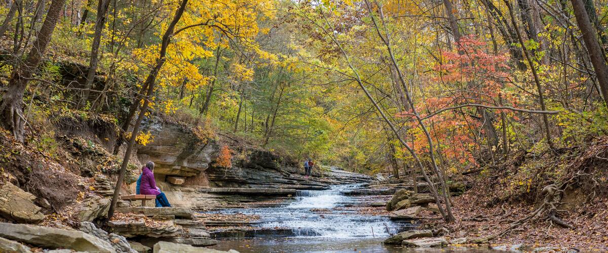 Tourists sitting on bench at Tanyard Creek Nature Trail Bella Vista, Northwest Arkansas