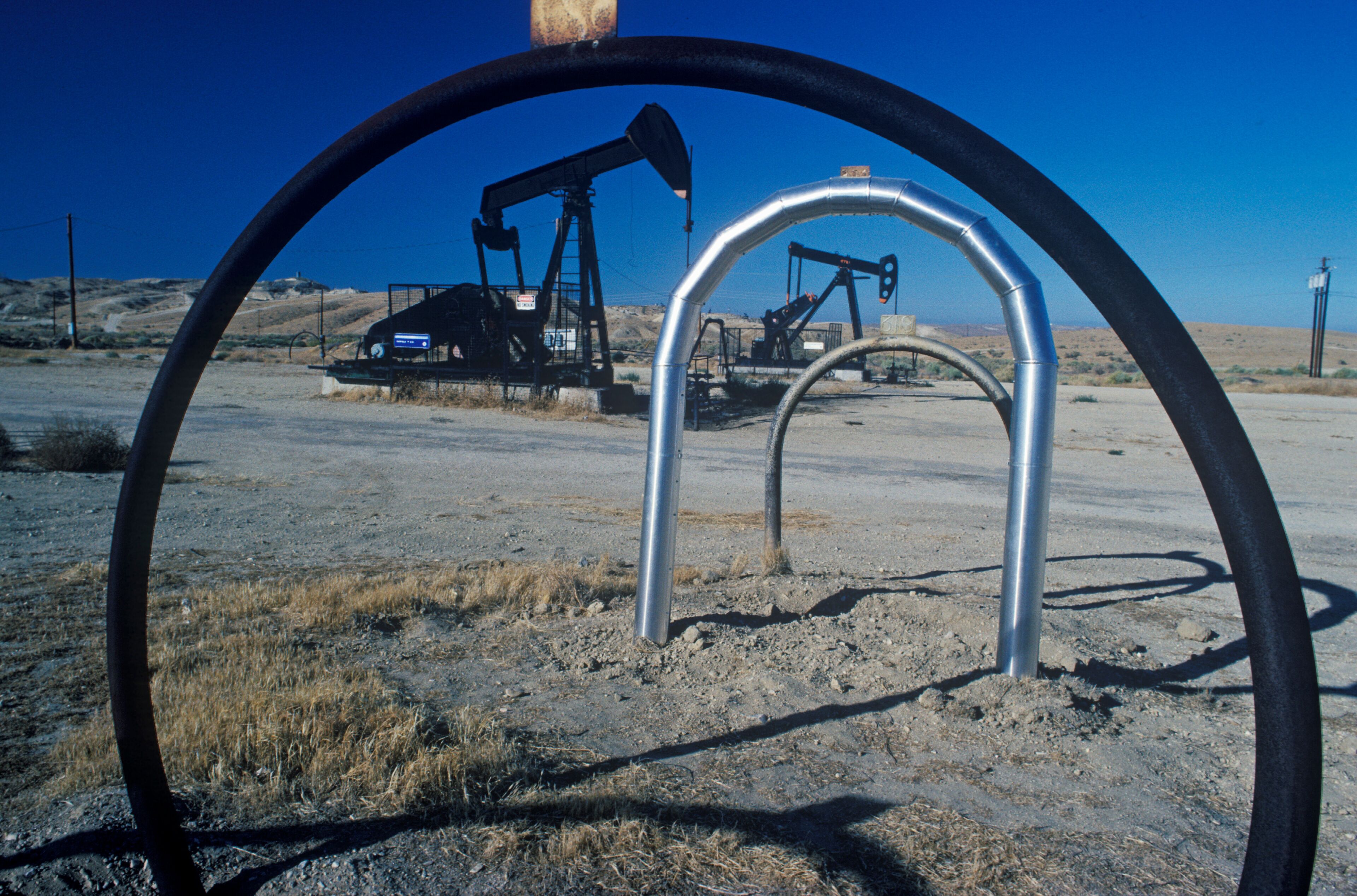 An oil pumpjack in a desert landscape.