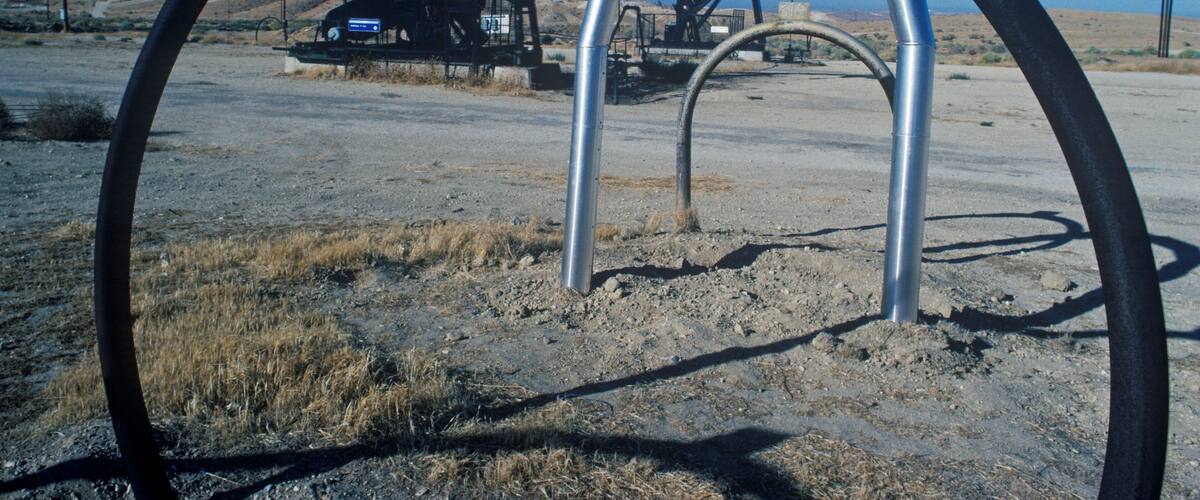 An oil pumpjack in a desert landscape.