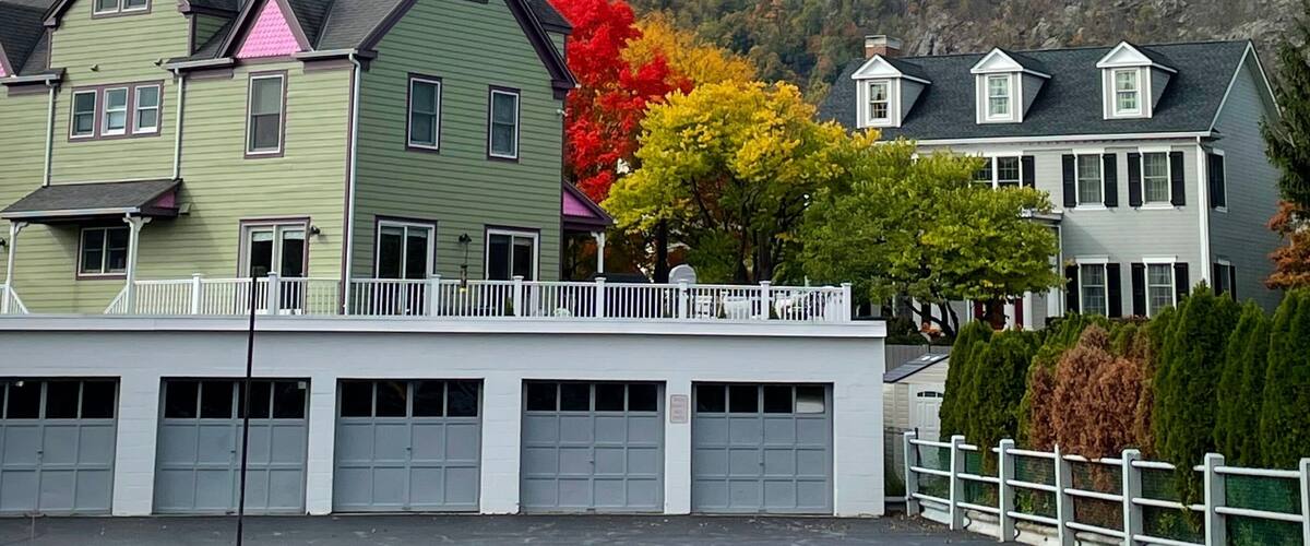 A row of houses with a mountain in the background.