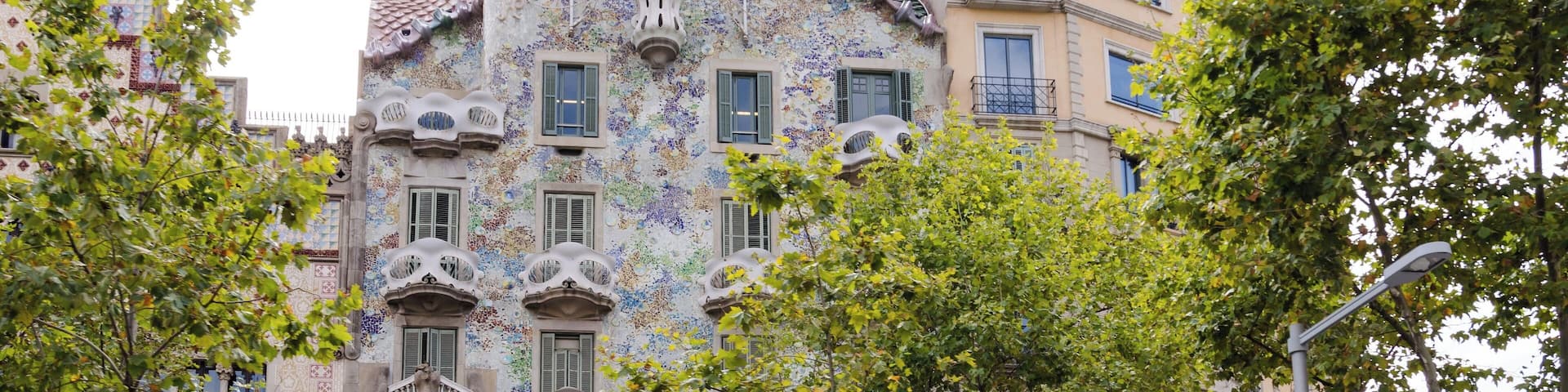 A colorful building with intricate tile work and green balconies.