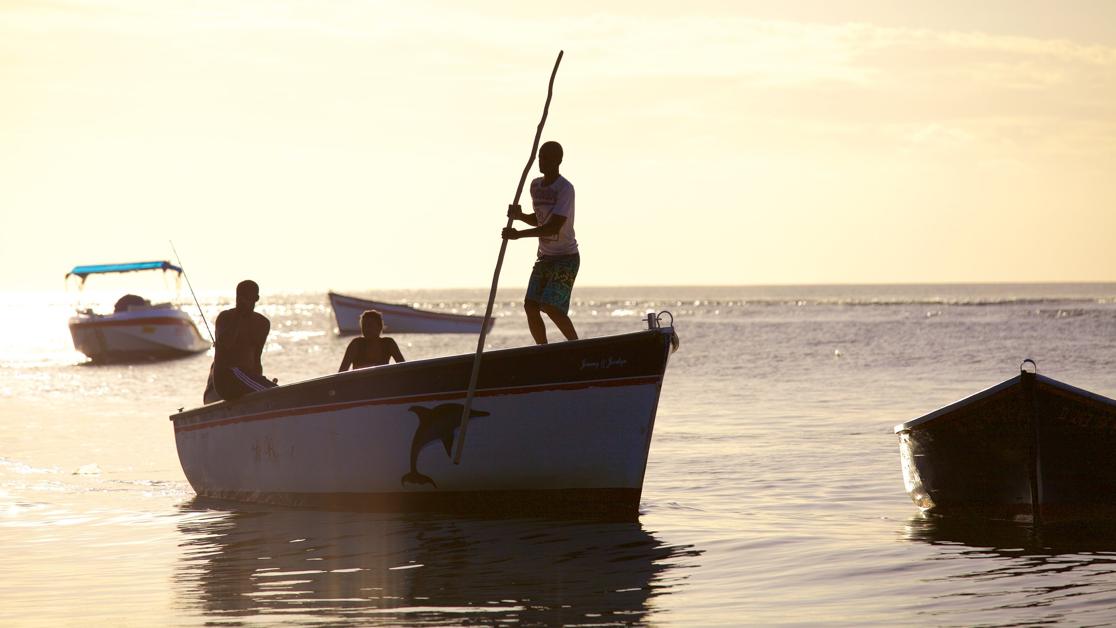 Tamarin which includes a sunset and boating as well as a small group of people