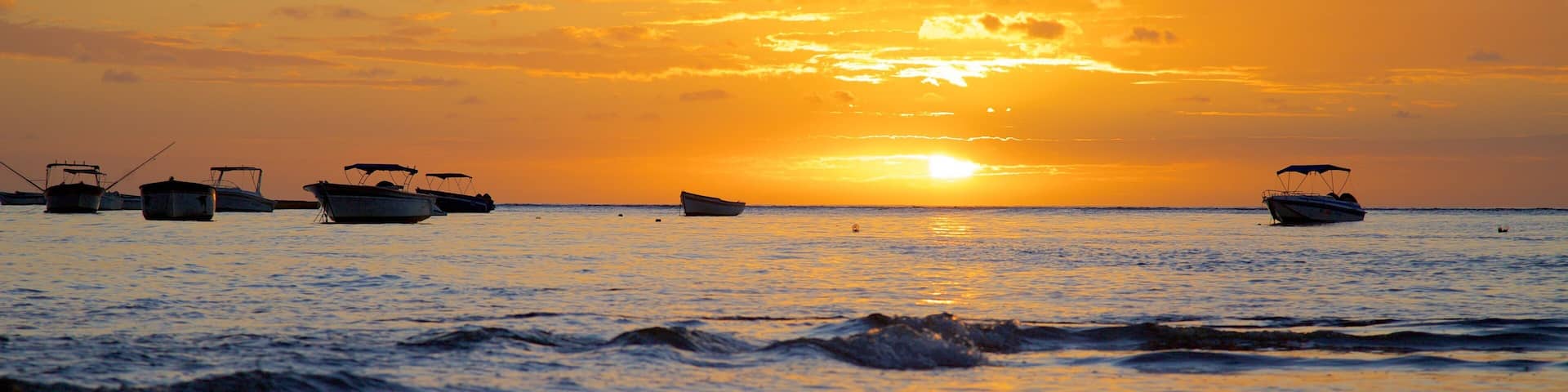 Tamarin showing boating, a sunset and a beach