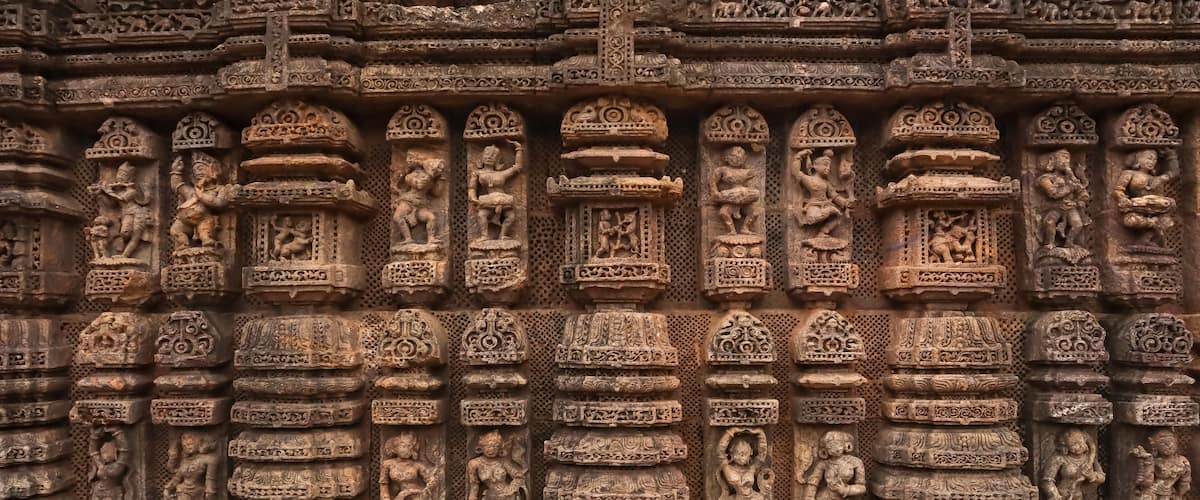 Carvings of musicians and dancers that almost completely cover the platform, walls and pillars of the hall on Bhoga Mandapa or the dance hall, Sun Temple, Konark, India.