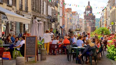 Riom mostrando señalización, comer al aire libre y una ciudad