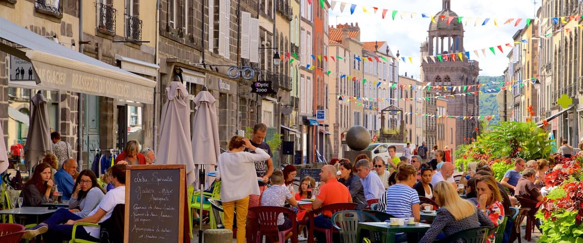 A bustling outdoor café with people dining and socializing.