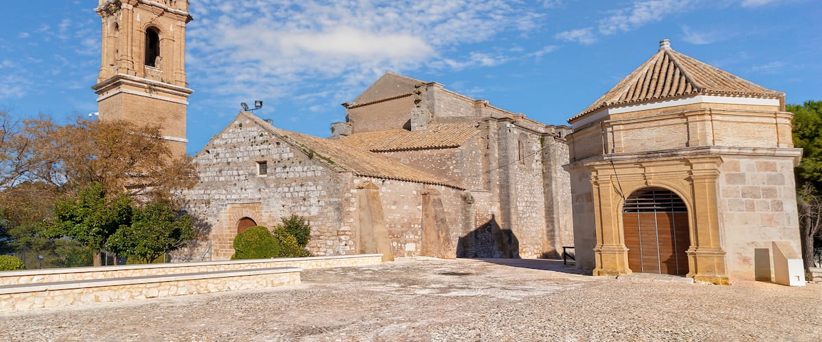 A historic church with a bell tower and a small adjacent building.