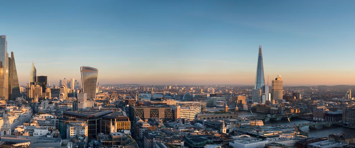 A cityscape with prominent skyscrapers, including a distinctive curved building and a tall, slender tower.