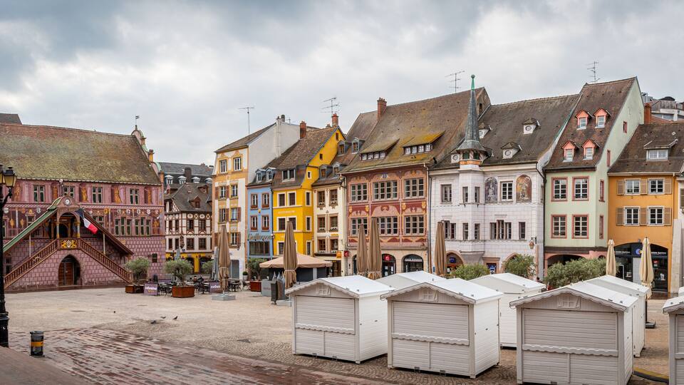 A historic European town square with colorful buildings and traditional architecture.