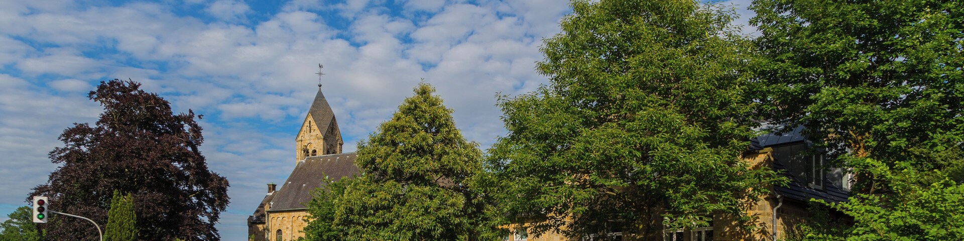 The Protestant Church of Peace (Evangelische Friedenskirche) and the former Protestant School (Alte Evangelische Schule) in Hörstel, Kreis Steinfurt, North Rhine-Westphalia, Germany. Both sandstone buildings are listed cultural heritage monuments.