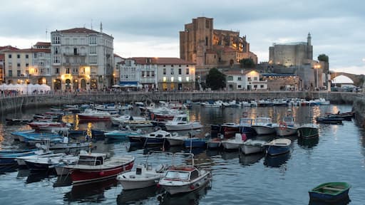 Harbour of Castro Urdiales in Cantabria, Spain. Church of Santa María de la Asunción and lighthouse in Castle of Santa Ana at the background.