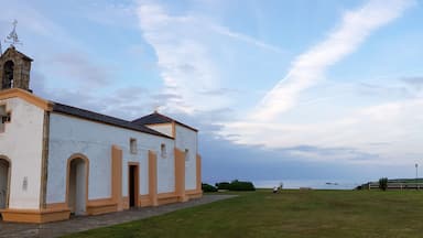 A small church with a bell tower and a clear sky.