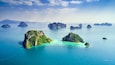 Surrounding Islands of Koh Yao Noi, Phuket, Thailand green lush tropical island in a blue and turquoise sea with islands in the background and clouds with sun beams shining through, drone aerial photo