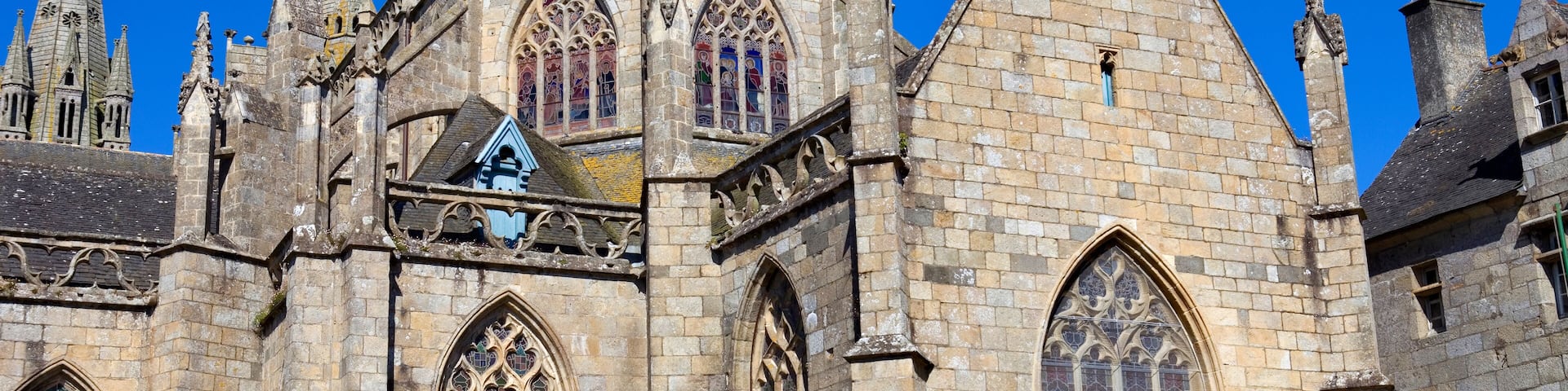 A historic cathedral with pointed arches, stained glass windows, and a prominent spire.