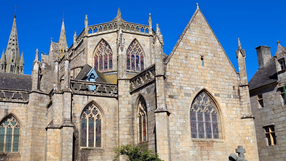 A historic cathedral with pointed arches, stained glass windows, and a prominent spire.