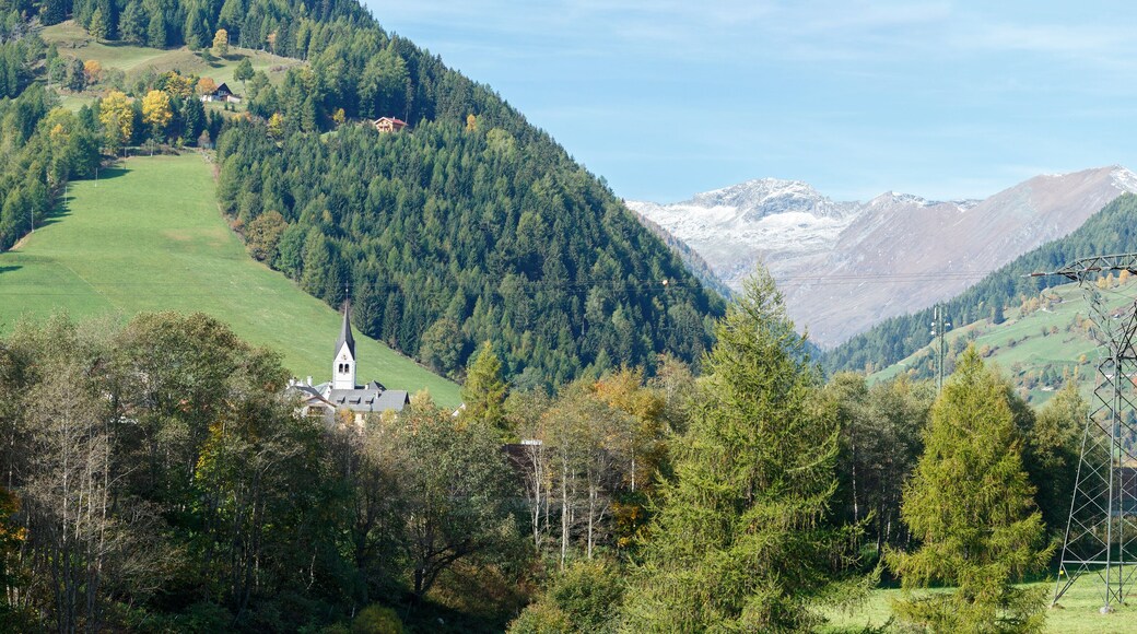 Panorama of the Alps mountains near the town of Rennweg am Katschberg with the power transmission line tower in the foreground. Carinthia, Austria.