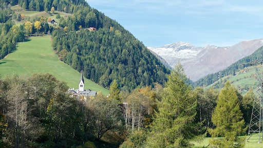 Panorama of the Alps mountains near the town of Rennweg am Katschberg with the power transmission line tower in the foreground. Carinthia, Austria.