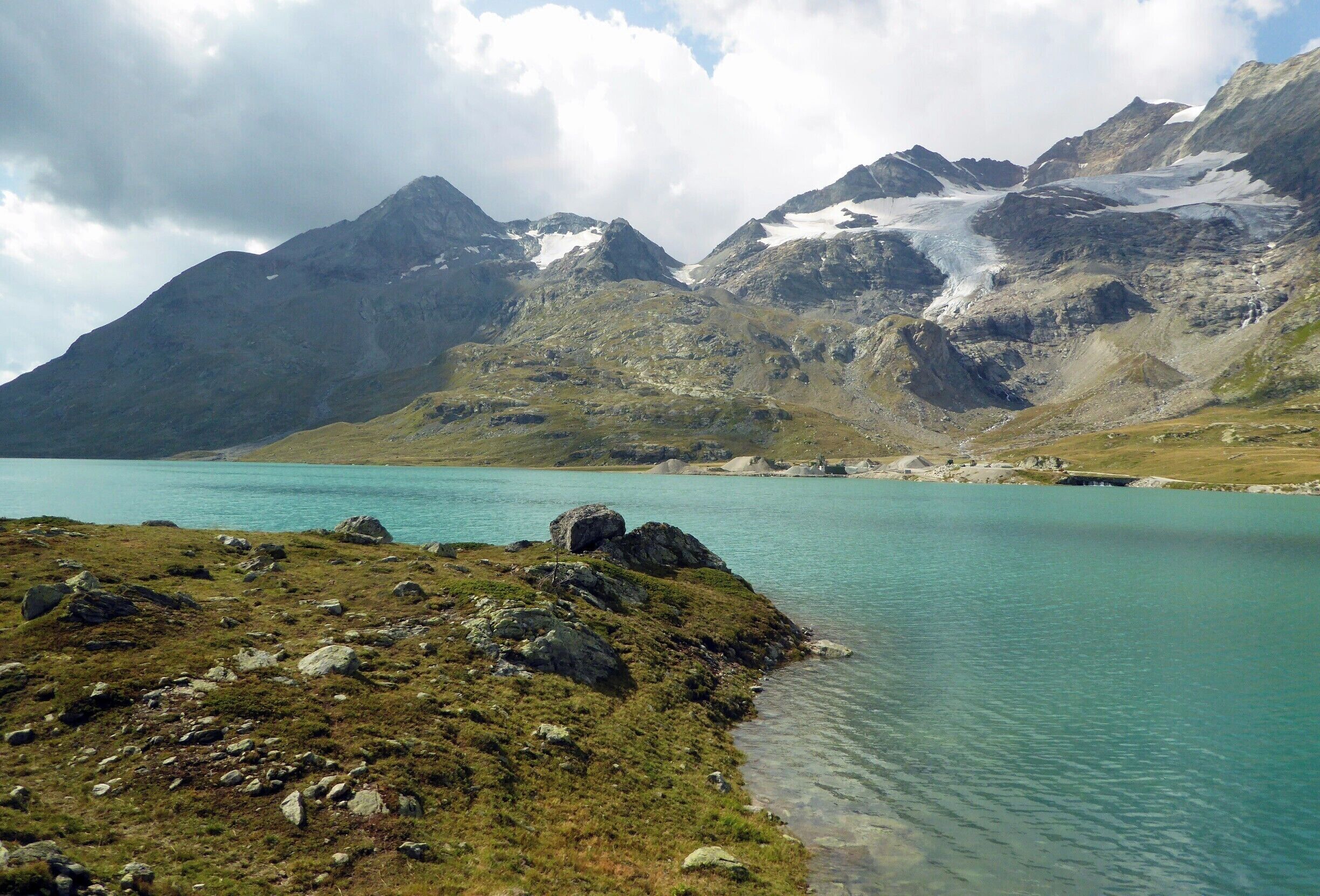Lago Bianco is a reservoir at the Bernina Pass, Switzerland. Its elevation is 2,234 m (7,329 ft). The reservoir was formed by the two dams Scala and Arlas on the site of two natural lakes (Lago Bianco and Lago della Scala). The narrow-gauge rail track provides the highest regularly scheduled train service in Europe at this site. #GreatOutdoors