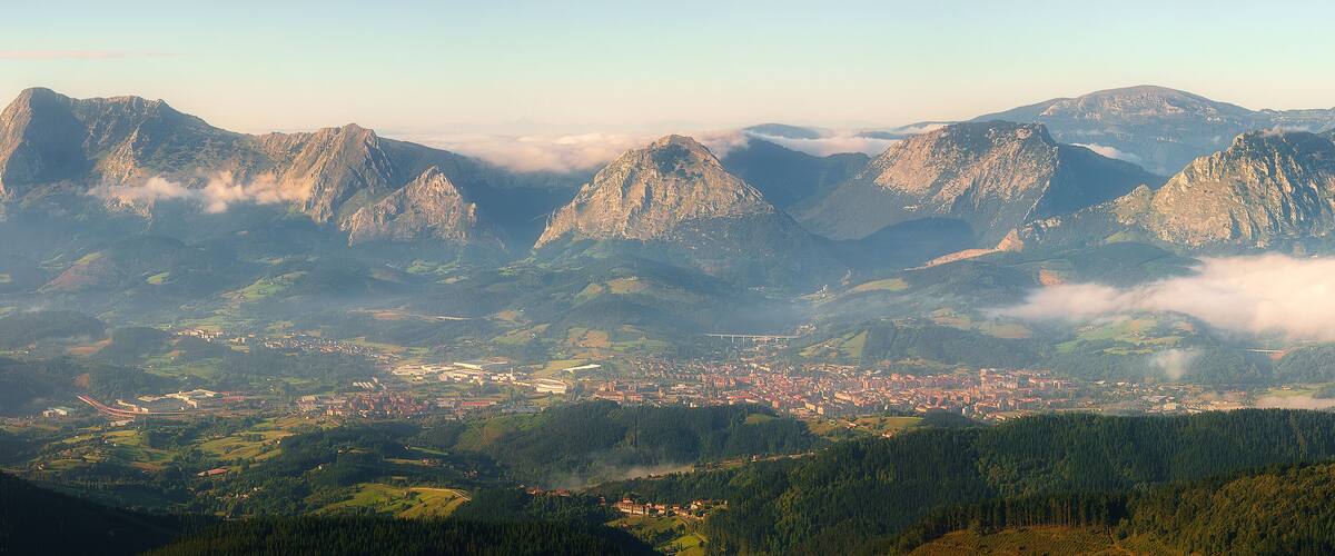 A mountainous landscape with a town nestled in the valley.