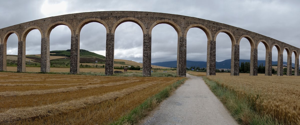 A stone viaduct with multiple arches spanning a rural landscape.