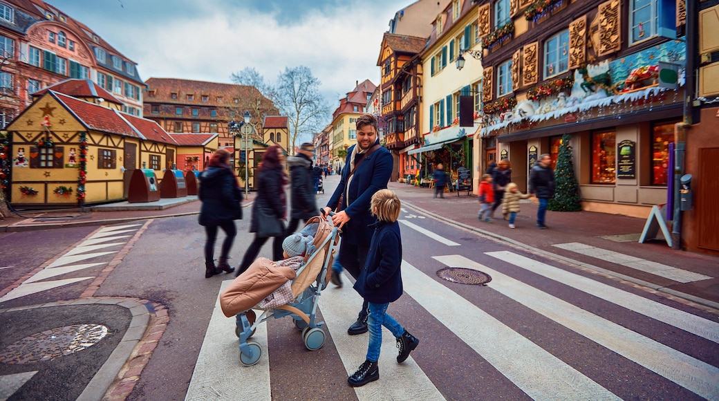 happy people crossing the street of Colmar town during Christmas holidays. Alsace, France
